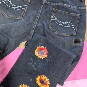 Faded black bootcut jeans with daisy print